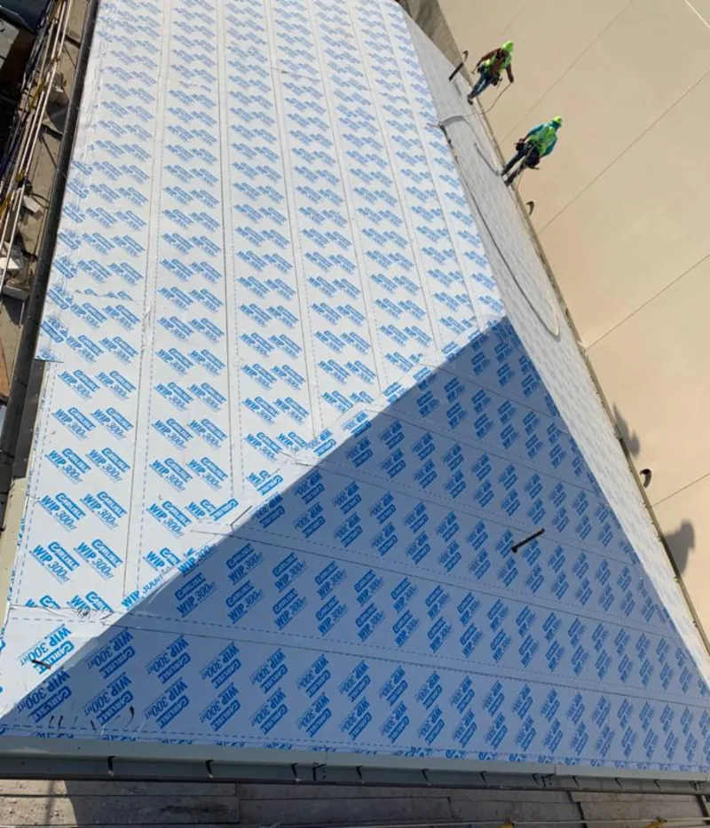 Professional roofers installing underlayment on a metal roof in Pinellas Park